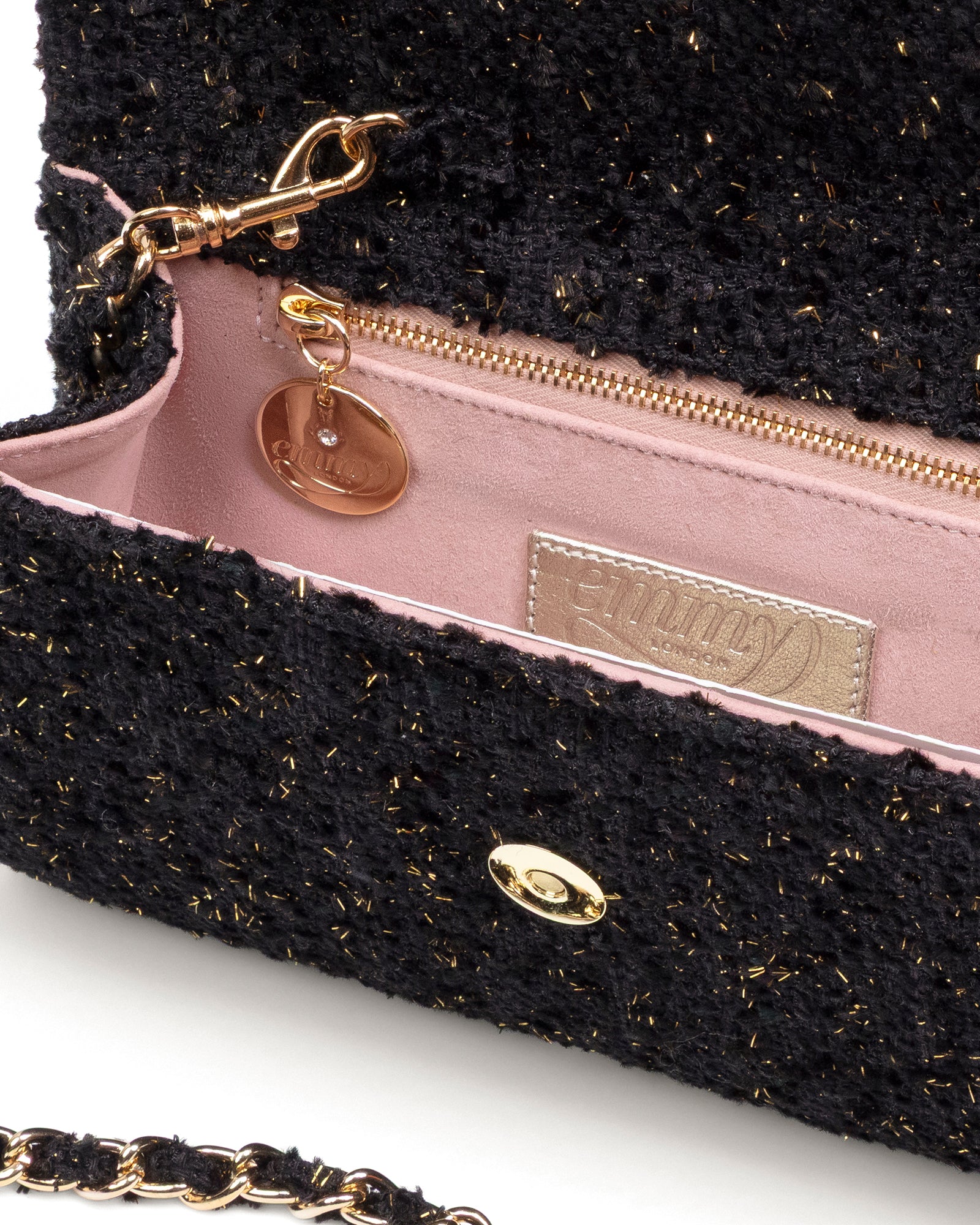 Black textured handbag with gold chain strap and visible brand logo on a white background image