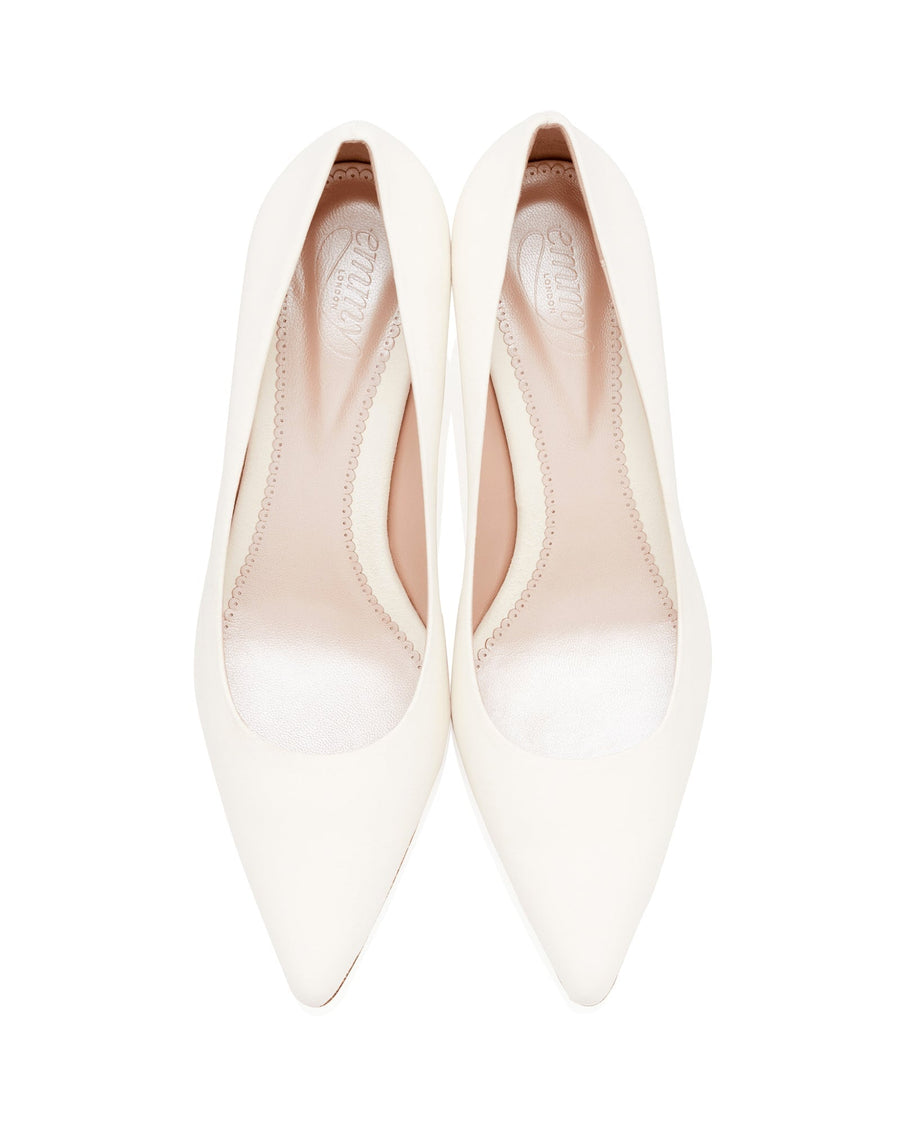 White pointed-toe heels are displayed from a top-down angle against a plain white background. The shoes feature a sleek design with a smooth finish, showcasing a minimalist aesthetic. image