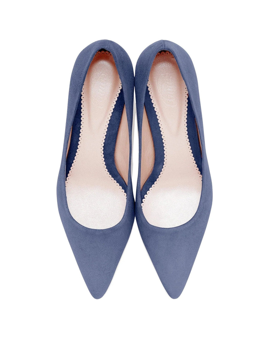 Pointed-toe pumps in a soft blue suede material. The shoes feature a sleek design with a low-cut vamp and a smooth interior lining. The image is taken from a top-down angle against a clean white background, showcasing the elegant silhouette of the shoes. image