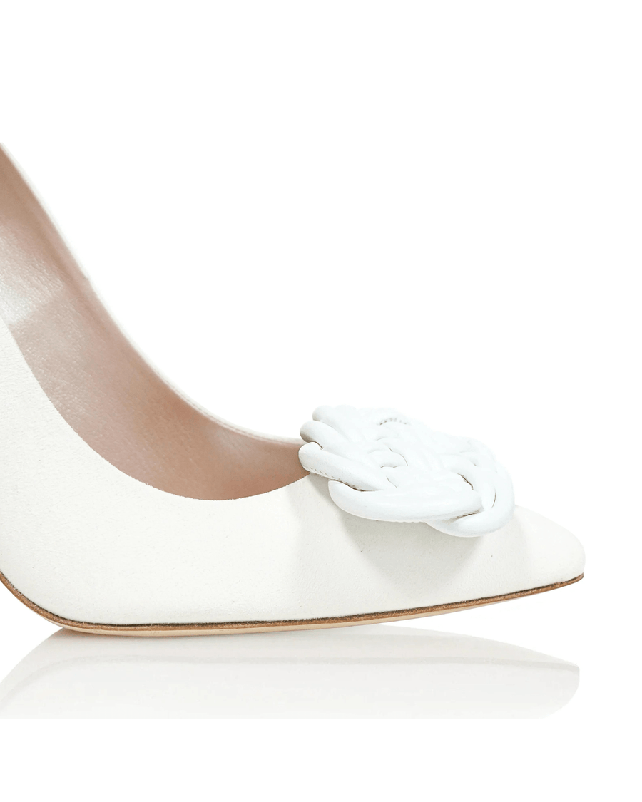 White suede heels featuring a braided white detail on the toe. The image is taken from a close-up angle, highlighting the elegant design and smooth finish of the shoe against a clean, white background. image