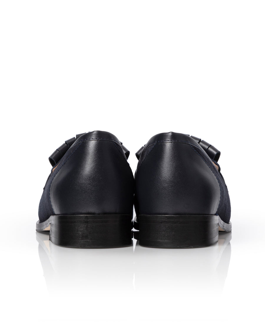 Navy leather loafer shoes on a white background image