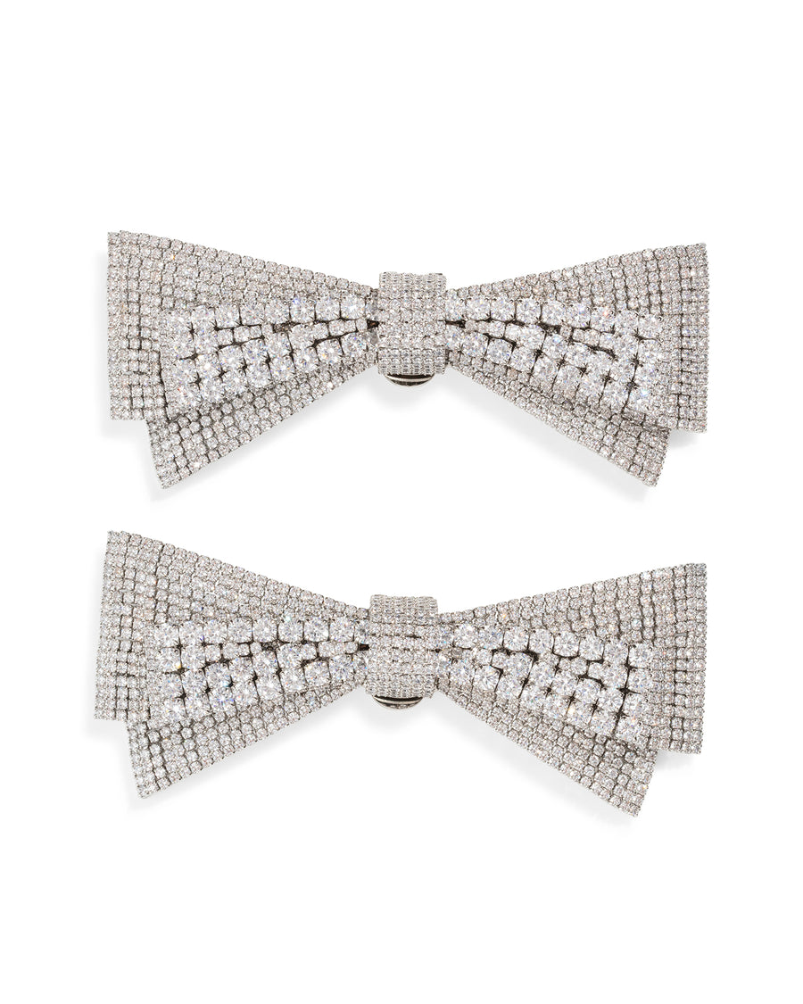 Two silver bow-shaped shoe clips
 with gemstones on a white background image