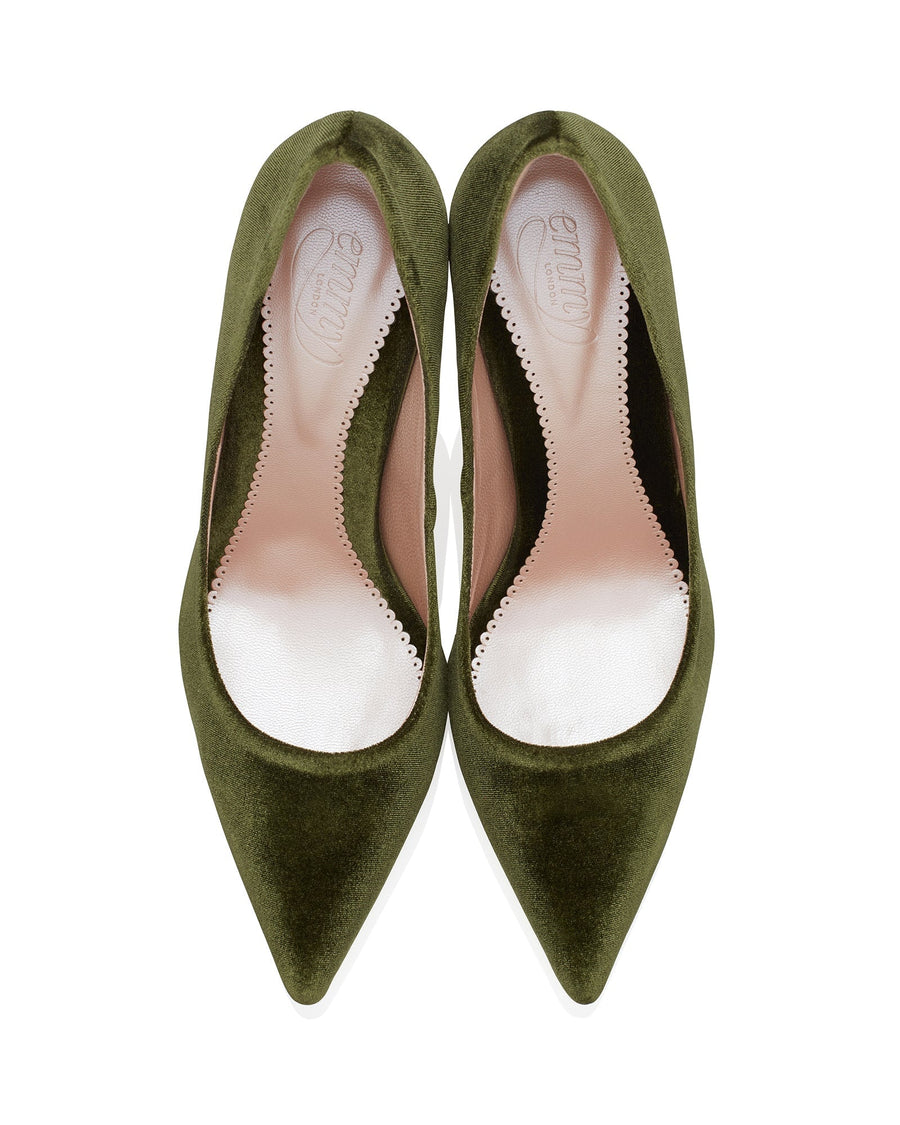 Green suede pointed-toe heels with a sleek design, showcasing a smooth interior lining. The shoes are displayed from a top-down angle against a white background, emphasizing their elegant shape and texture. image