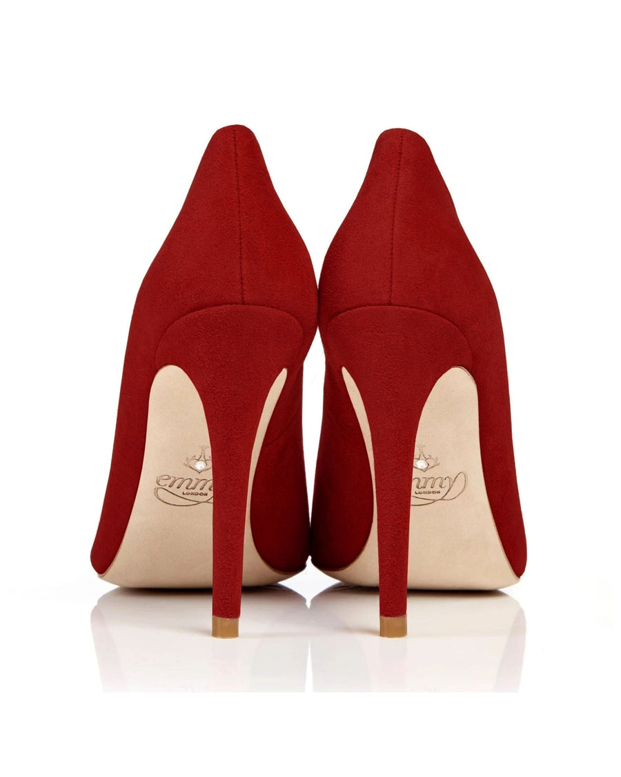 Red suede high heels with a pointed toe, shown from the back against a white background. The heels are sleek and elegant, emphasizing their height and stylish design. image