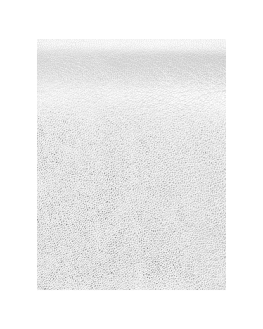The image shows a close-up of a textured white leather material. The background is plain and neutral, emphasizing the details of the leather's surface. There are no shoes or heels present in the image. image