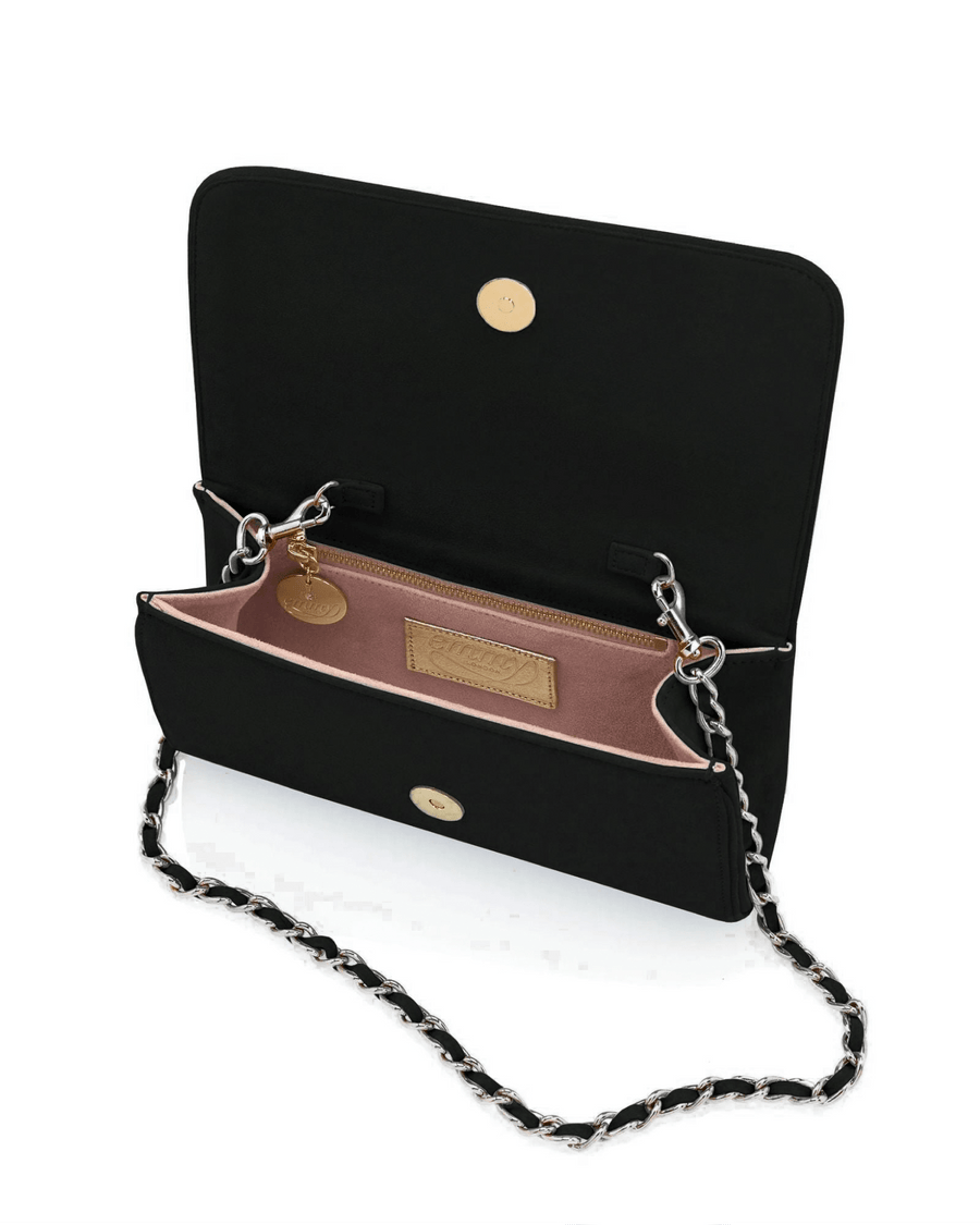 Black suede handbag with a chain strap, featuring a spacious interior lined in soft pink material. The bag is open, showcasing a small pocket and a gold charm inside. The image is taken from a front angle against a white background, highlighting the bag's elegant design. image
