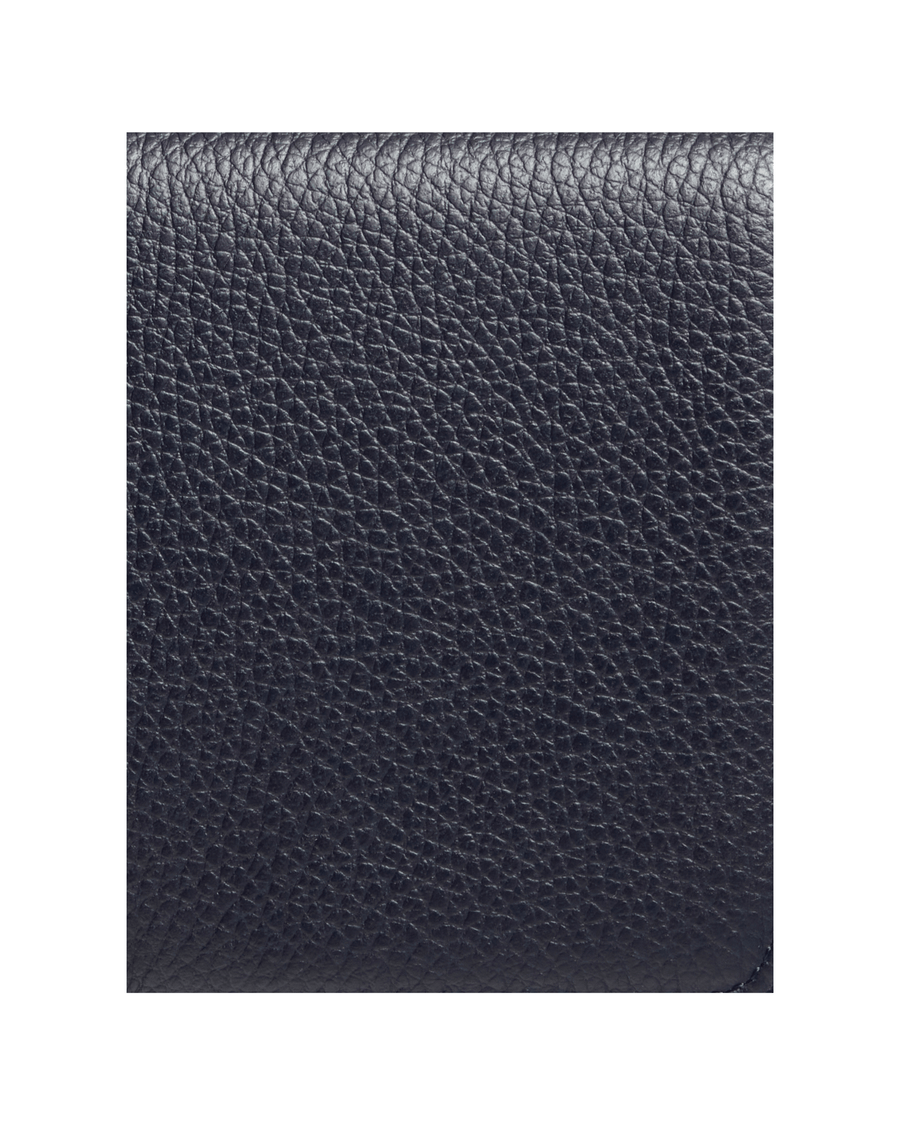 This image features a close-up view of a textured dark leather material, showcasing its grainy surface. The background is plain, emphasizing the richness of the leather. No heel height or additional details are applicable. image