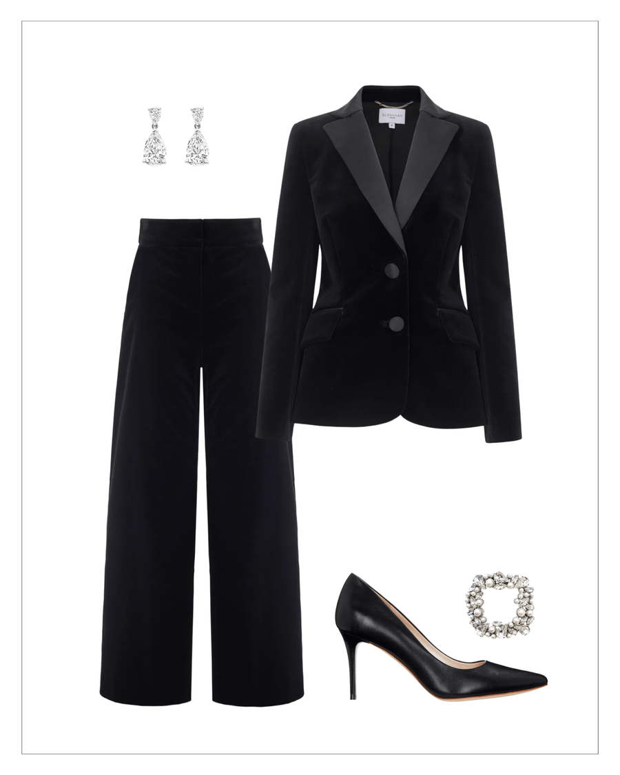Elegant black leather heels with a pointed toe, set against a minimalist white background. The shoes are styled with a chic black velvet blazer and wide-leg trousers, complemented by sparkling silver earrings and a statement brooch. The image captures the ensemble from a frontal angle, showcasing the polished look suitable for formal occasions. image
