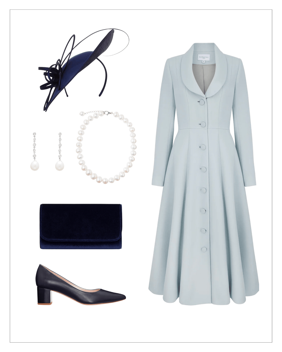 Elegant light blue dress with a fitted bodice and button-down front, paired with a navy clutch and matching navy leather heels. The outfit is complemented by a pearl necklace and drop earrings, with a stylish navy fascinator positioned above. The image is set against a clean white background, showcasing the ensemble in a flat lay arrangement. image