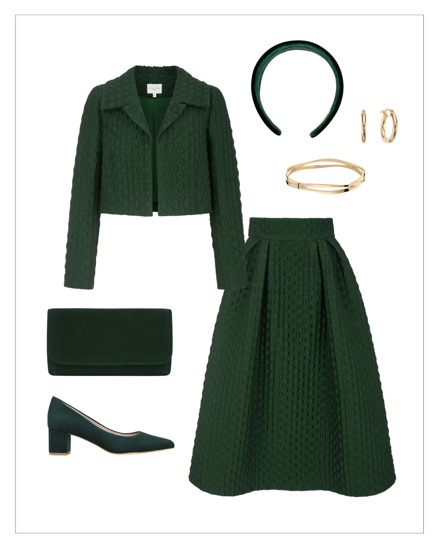 Elegant green ensemble featuring a textured jacket and matching skirt, complemented by a green clutch and accessories. The model is wearing green leather heels with a block heel, approximately 2.5 inches in height. The image is styled against a clean, white background, showcasing the outfit from a top-down angle. image