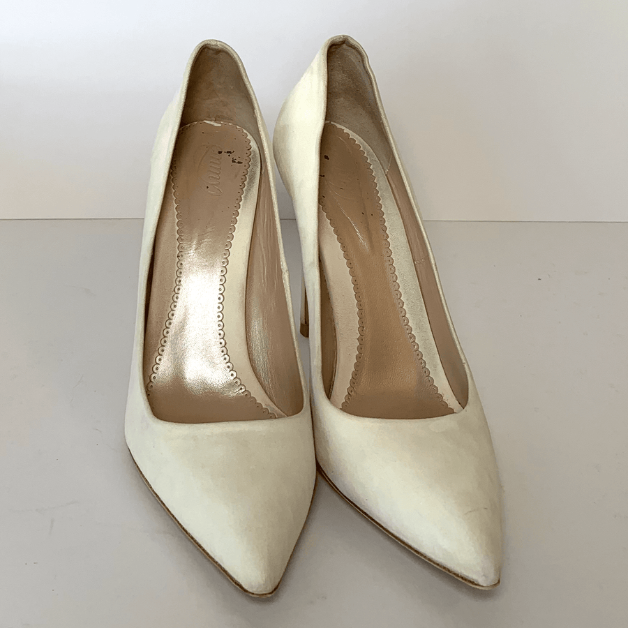 White suede high heels with a pointed toe design, displayed against a plain white background. The shoes are positioned side by side, showcasing their sleek silhouette and elegant shape. image