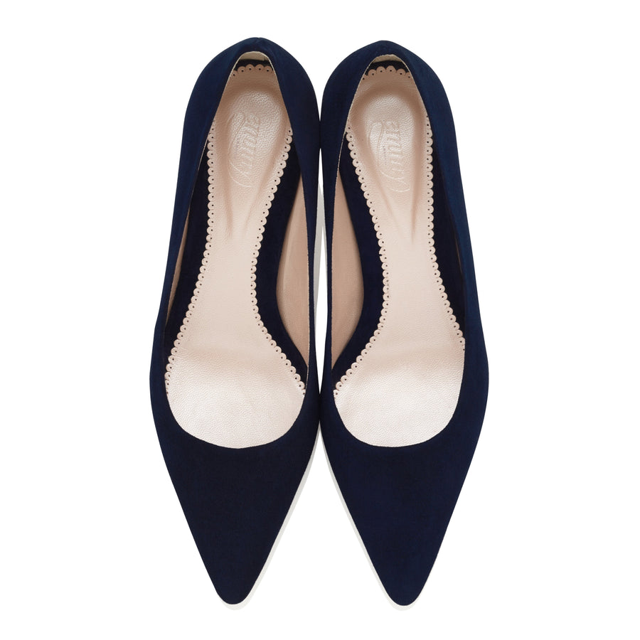 Navy suede pointed-toe heels with a sleek design, featuring a smooth interior and scalloped edges. The shoes are displayed from a top-down angle against a white background. image